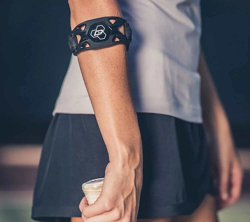 Person wearing a tennis elbow brace support band on the forearm - Greenlight Chiropractic & Wellness Lab