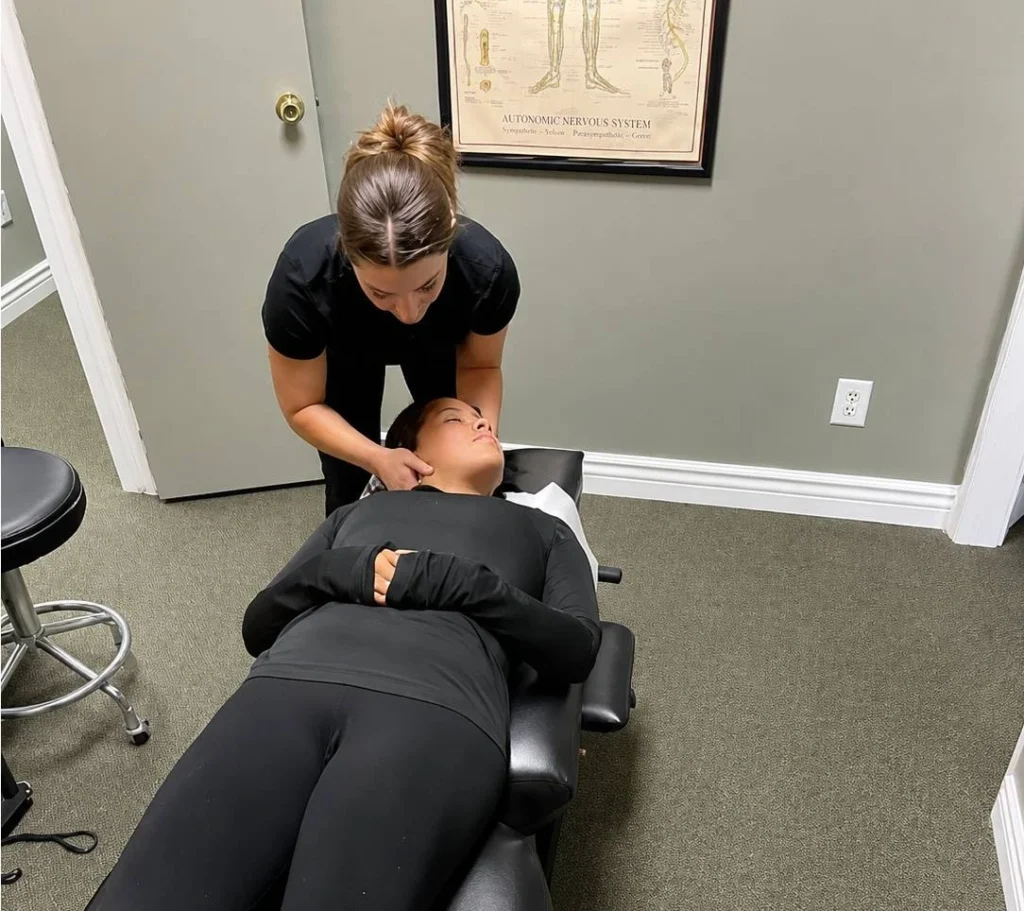 Chiropractor performing cervical neck adjustment at Greenlight Chiropractic & Wellness Lab