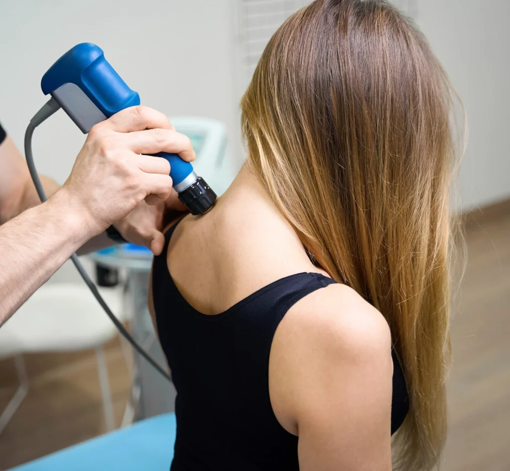 Shockwave therapy being applied to a patient's shoulder for pain treatment - Greenlight Chiropractic & Wellness Lab